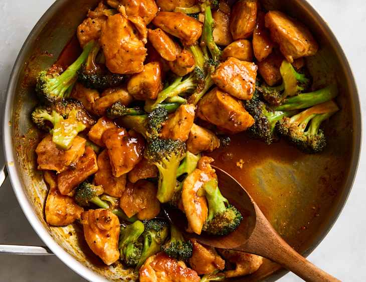 overhead shot of harissa orange chicken and broccoli bites in a pan